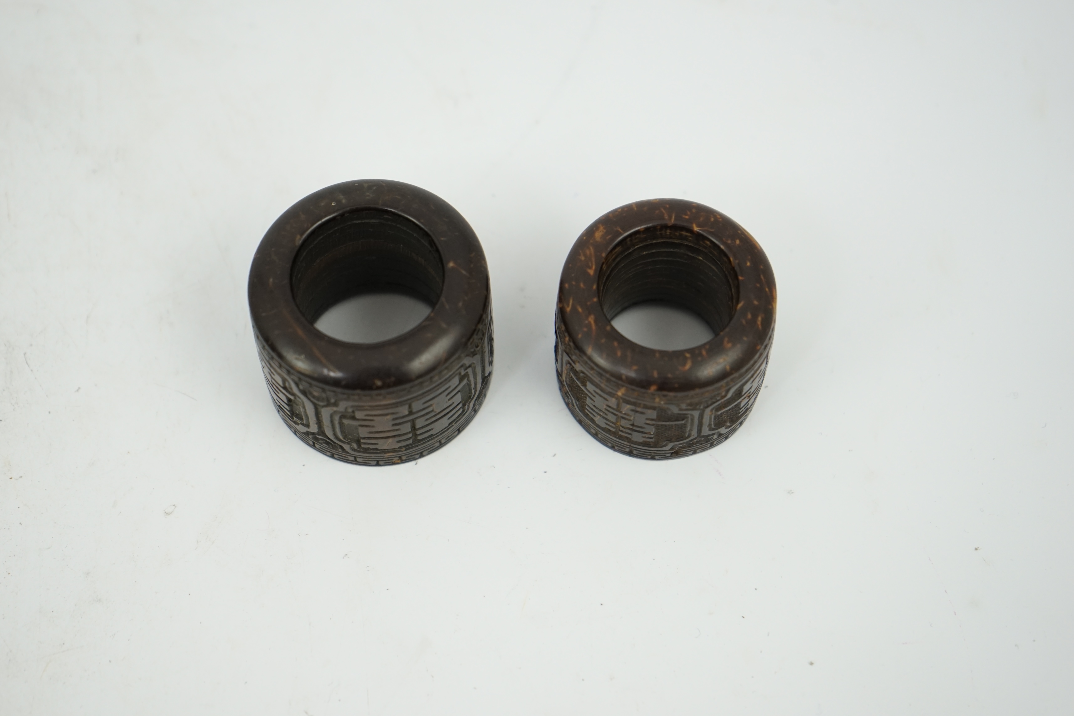 A pair of rare Chinese Straits palm wood archer's thumb rings, 19th century